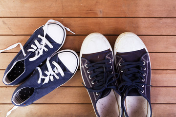Old canvas shoes on a wooden floor
