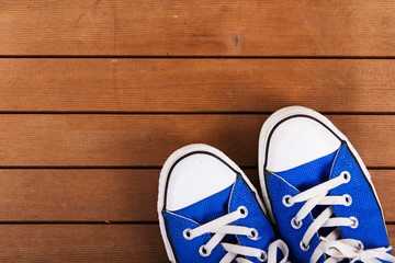 Old canvas shoes on a wooden floor
