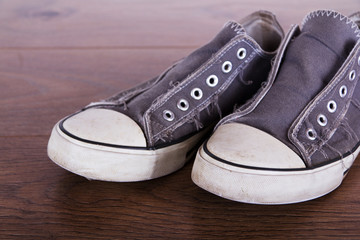 Old canvas shoes on a wooden floor