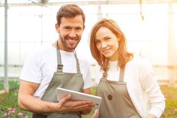 Obraz premium Team of florist working together at the plants nursery