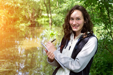 Fototapeta premium Young attractive biologist woman working on water analysis