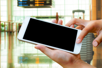 woman hand hold and touch screen smartphone,tablet,cellphone in the airport terminal