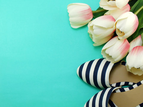womens flats shoes and tulips flower on green background