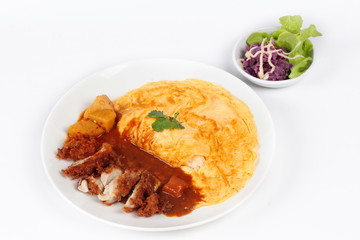 Omelet rice with deep fried chicken in Japanese yellow curry  with butter mashed potatoes salad  on white. Side view.