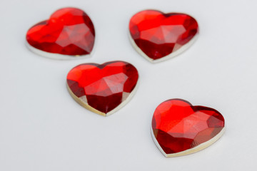 Four hearts in red glass.