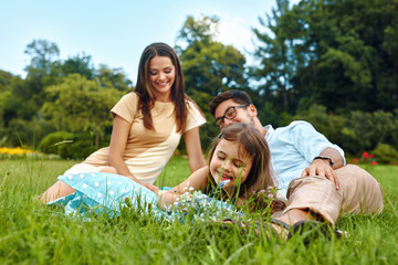 Fototapeta premium Happy Young Family In Park. Parents And Kids Having Fun, Playing