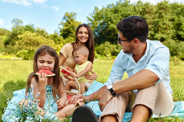 Family On Picnic. Happy Young Family Having Fun In Nature