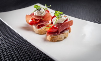 bruschetta with parma on white plate