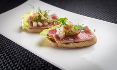 bruschetta with tuna on white palat