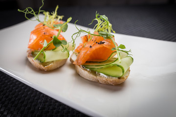 bruschetta with salmon on white palat
