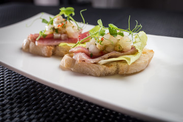 bruschetta with tuna on white palat