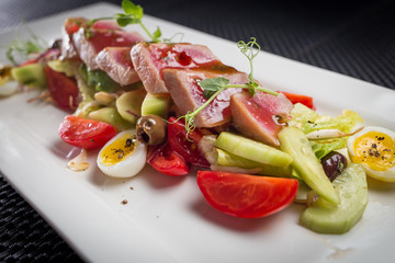 salad with tuna on white plate