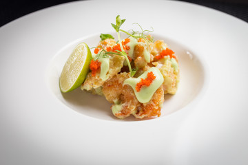 shrimp tempura with roe on white plate, restaurant