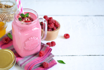 Berry smoothie in a glass jar on the breakfast with raspberries
