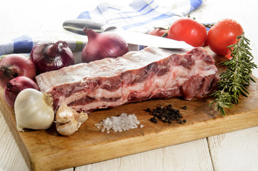 raw pork ribs on a wooden board
