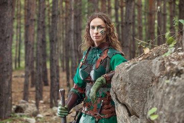 Elf woman in green leather armor with the sword