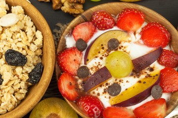 Healthy breakfast with cereals and colorful fruits. Yogurt with fruit and oatmeal. Meals for successful athletes. Food for kids.
