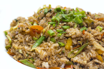pilaf with vegetables on a white background in the restaurant