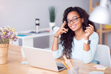 Positive woman sitting at the table