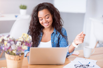 Cheerful woman using laptop