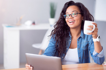 Cheerful delighted woman resting at the table