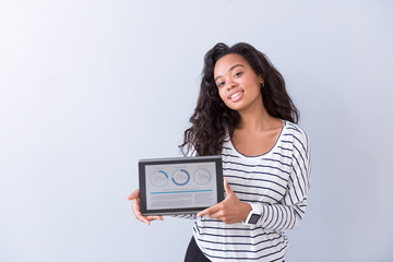 Fototapeta premium Cheerful woman holding tablet