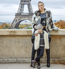 mother and child standing in front of Eiffel tower