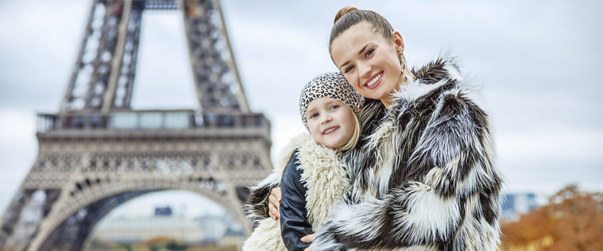mother and child in front of Eiffel tower in Paris embracing