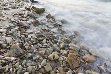 sea waves on the stone beach at sunset, Zakynthos, Greece