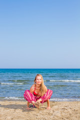 Young woman practicing morning meditation at the beach