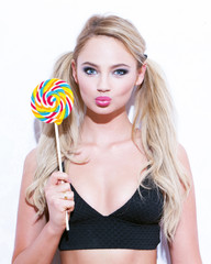 Sexy blonde woman with double ponytails and lollipop