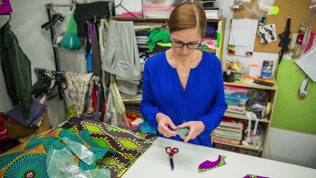 Woman working in messy tailor studio