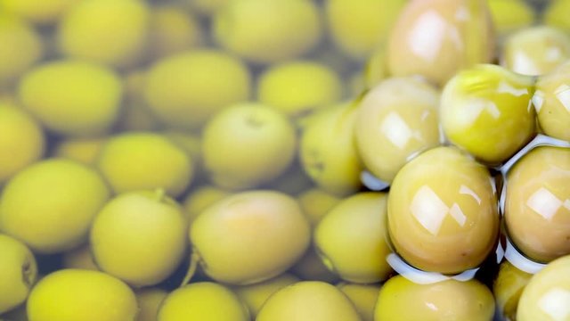 Pouring olive oil on green olives , 1080 HD video