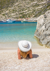Fototapeta na wymiar Young woman in white bikini looking at water