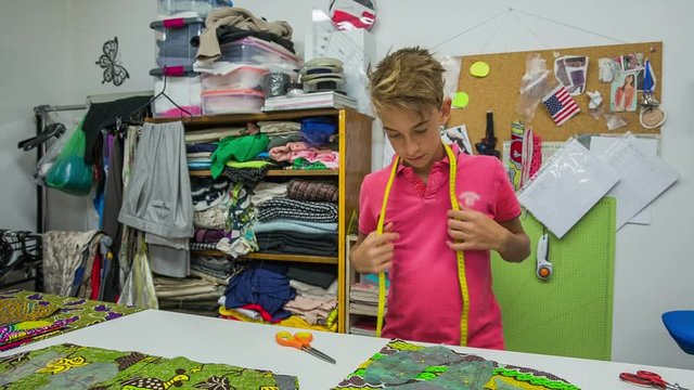 Young boy working in tailor shop