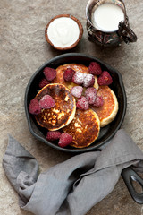 cottage cheese pancakes with raspberries on a gray marble background