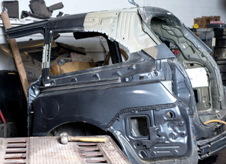 Auto body shop, half of body ready for welding