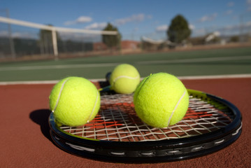 Tennis balls, court and racquet