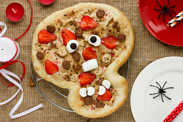 Sweet pizza in the form of funny skull to treat kids at Halloween