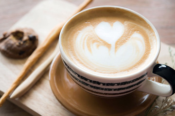 latte art coffee on the wood table and morning light in coffee s