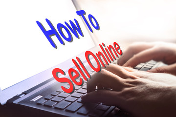 How To Sell Online text on hand typing on laptop.