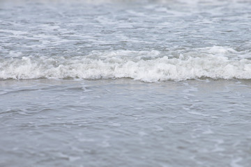 Soft wave of the sea on the beach.