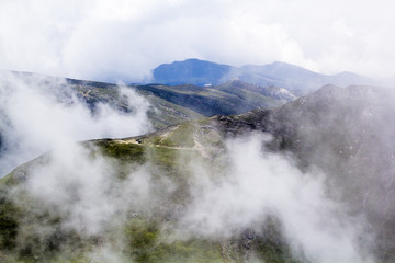 Landscape from Bucegi Mountains, part of Southern Carpathians in Romania in a very foggy day