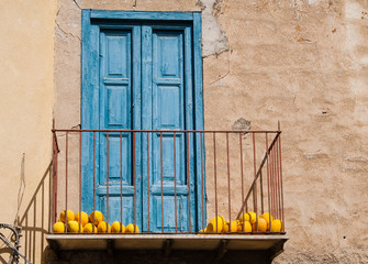 Balcony with yellow melons. Sicily. Italy