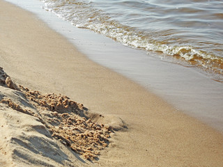 Soft wave of blue ocean on sandy beach.