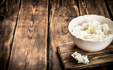 Fresh cottage cheese in a bowl .