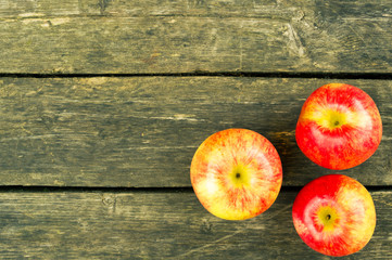 Three apples on  the old wooden background. Three apples view from above