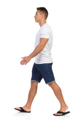 Walking Man In White T-shirt. Side View