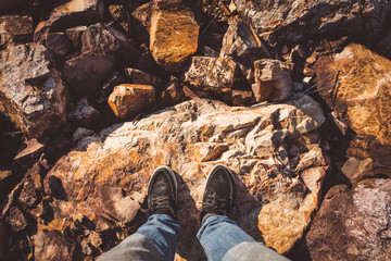Looking down on feet and a wooden surface, space for text. selective focus