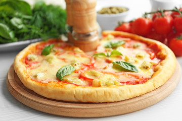 Delicious pizza on wooden cutting board